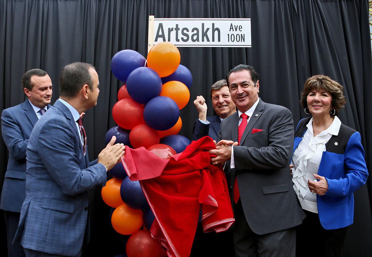 Permanent representative of the Nagorno Karabakh Republic (Artsakh) in the United States Robert Avetisyan, left, and Glendale city council members and unveil new street sign name during ceremony that changed the 100 north and south blocks of Maryland Ave. to Artsakh Ave., in Glendale on Tuesday, Oct. 2, 2018. The name change goes from Wilson to Harvard and businesses affected can apply for a $1,000 grant to use for expenses related to the name change. All five members of the city councilmembers were present, including mayor Zareh Sinanyan, second from left, Ara Najarian, center, Vartan Gharpetian, second from right and Paula Devine, right. Councilmember Vrej Agajanian was off to the left, out of frame.