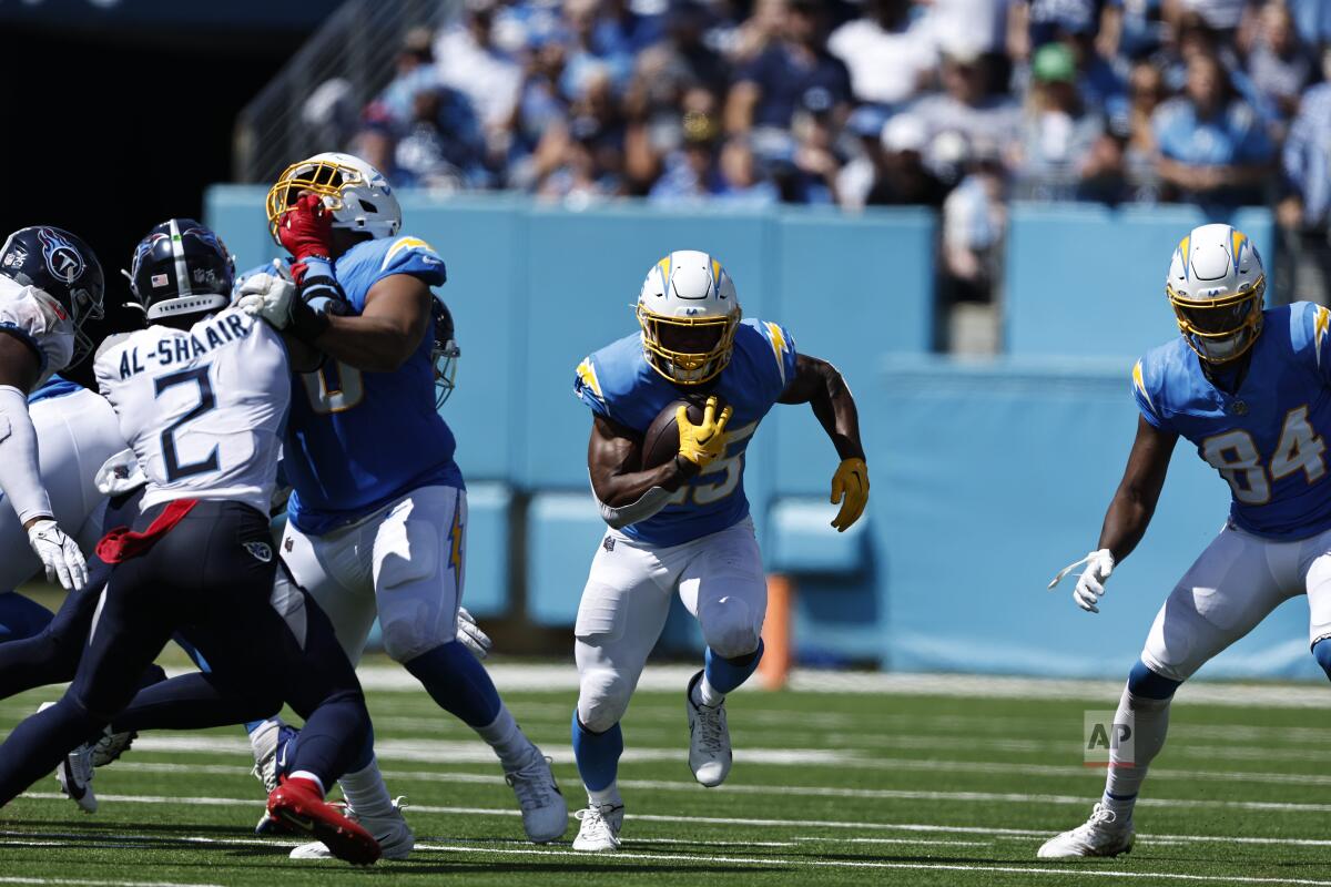 Chargers running back Joshua Kelley (25) runs for yardage against the Titans.