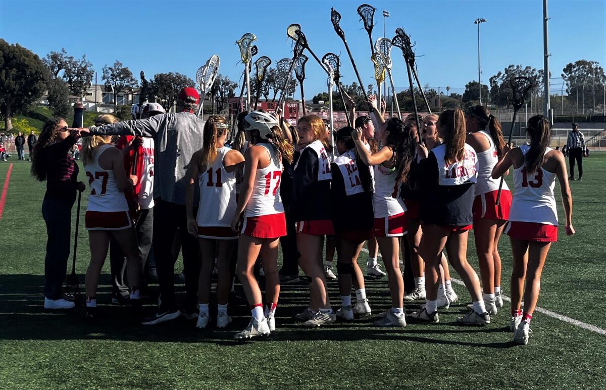 The Redondo Union girls' lacross team huddles after their game against Mira Costa on Wednesday afternoon.