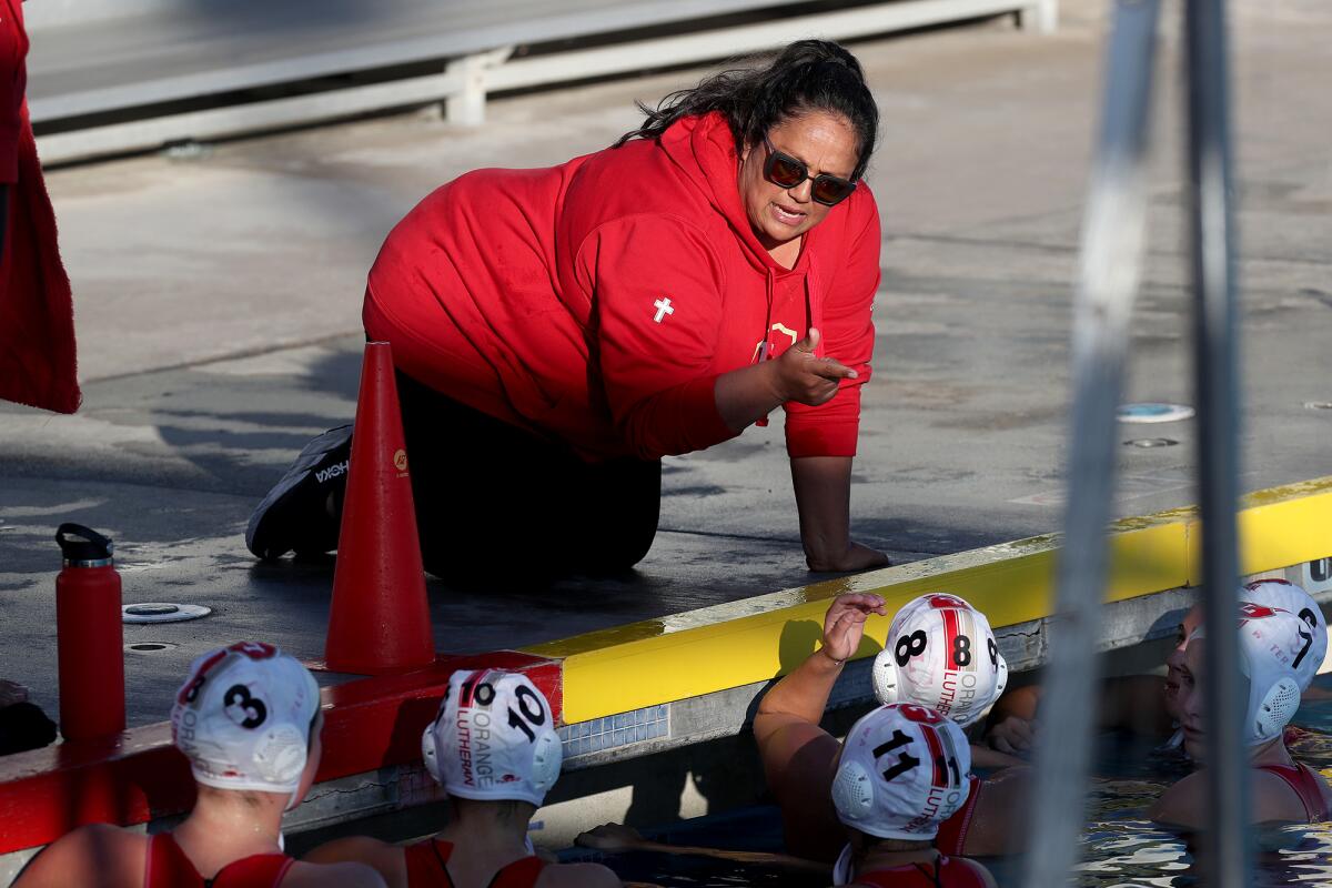 Orange Lutheran head coach Brenda Villa speaks to her players during the first half against Laguna Beach on Saturday.