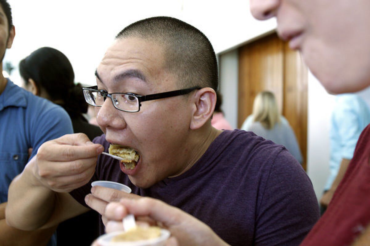 UCLA teaching assistant Andy Trang tastes a student's entry in the pie competition.