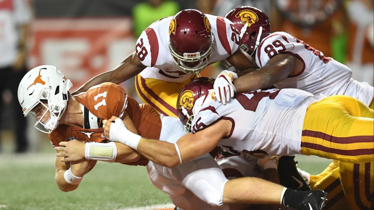 Texas quarterback Sam Ehlinger appears to be sacked inthe end zone by USC's C.J. Pollard (28) Christian rector (89) and Porter Gustin but the ball was ruled at the 1-yard line in the second quarter on Saturday.