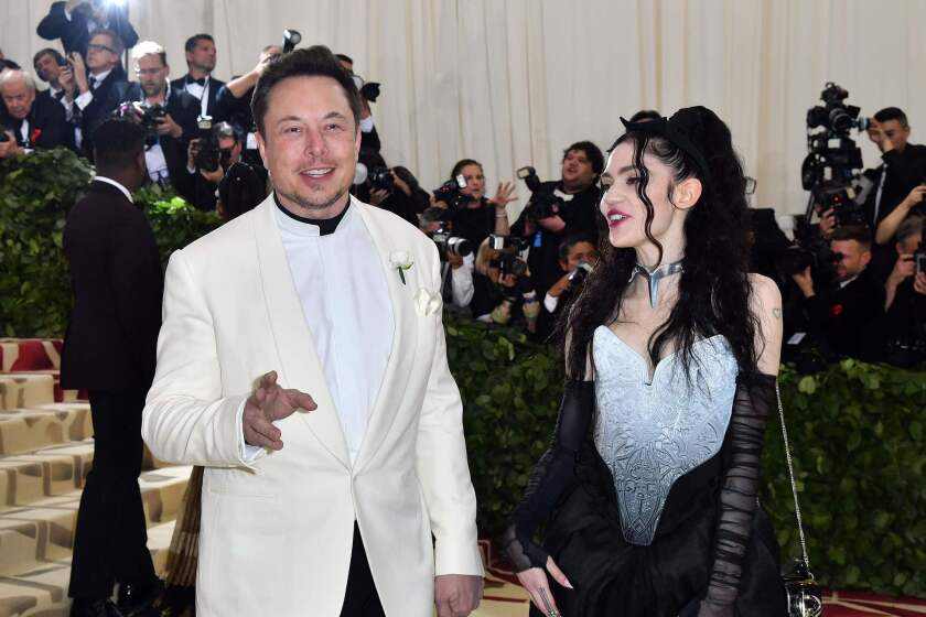 Elon Musk and Grimes arrive for the 2018 Met Gala on May 7, 2018, at the Metropolitan Museum of Art in New York. The Gala raises money for the Metropolitan Museum of Arts Costume Institute. The Gala's 2018 theme is Heavenly Bodies: Fashion and the Catholic Imagination. / AFP PHOTO / ANGELA WEISSANGELA WEISS/AFP/Getty Images ** OUTS - ELSENT, FPG, CM - OUTS * NM, PH, VA if sourced by CT, LA or MoD **