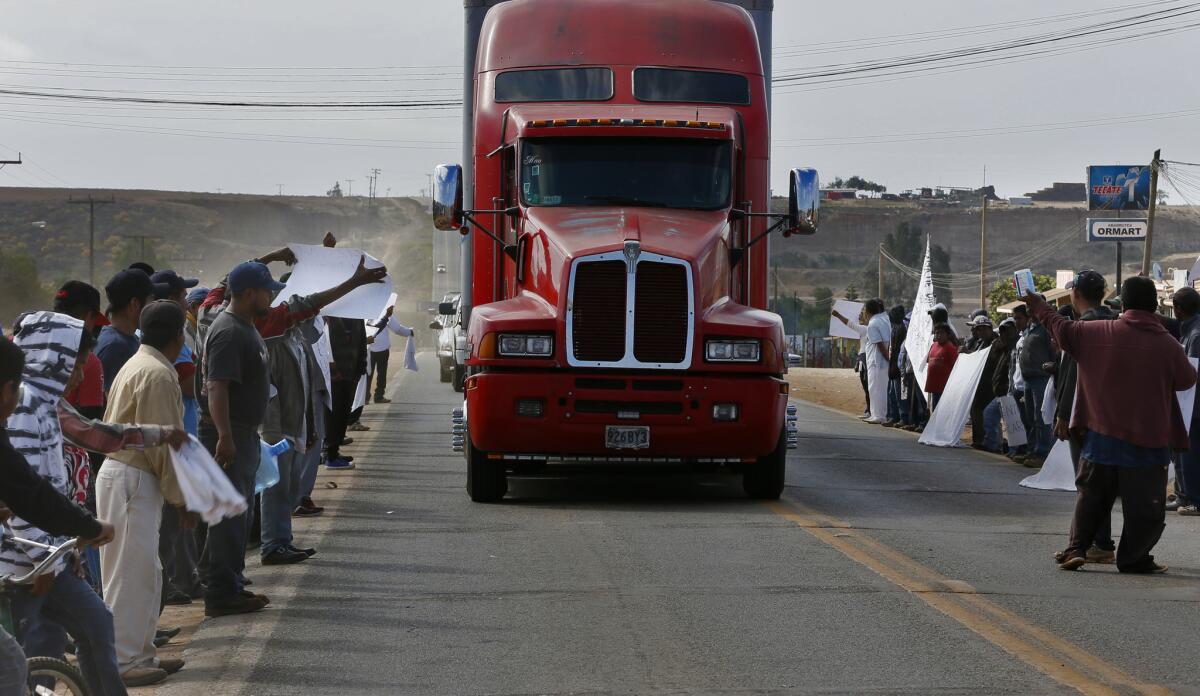 Striking farmworkers yell at a northbound produce truck last week in Colonet, in the Mexican state of Baja California.