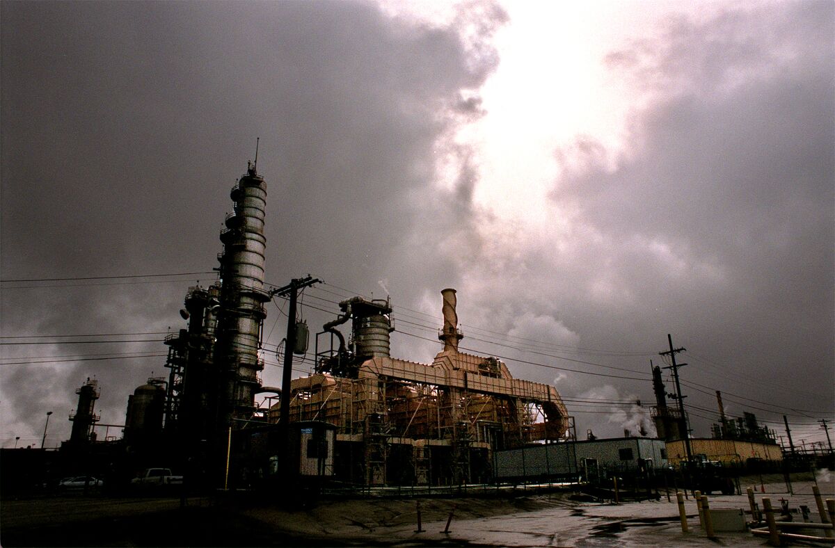 An oil refinery amid an overcast sky 