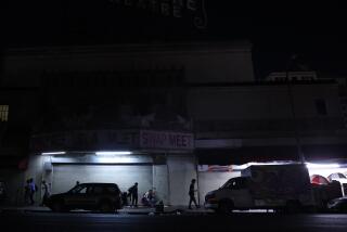 Los Angeles, CA - September 10: People walk by Westlake Theater near MacArthur Park on Tuesday, Sept. 10, 2024 in Los Angeles, CA. (Michael Blackshire / Los Angeles Times)