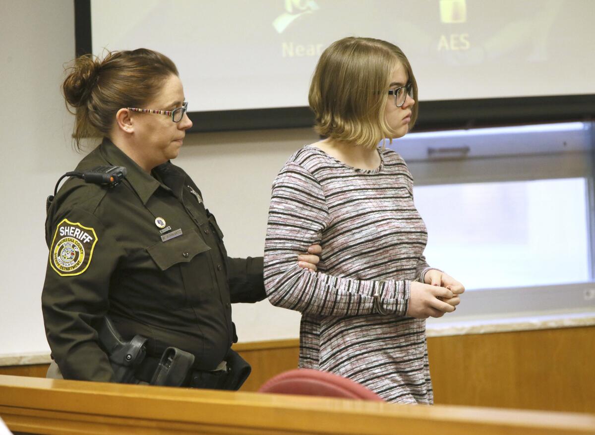 Morgan E. Geyser is escorted into a Waukesha County Court in Waukesha, Wis. on Nov. 11, 2016. She will plead guilty in a deal that calls for her to avoid prison time in the Slender Man case.