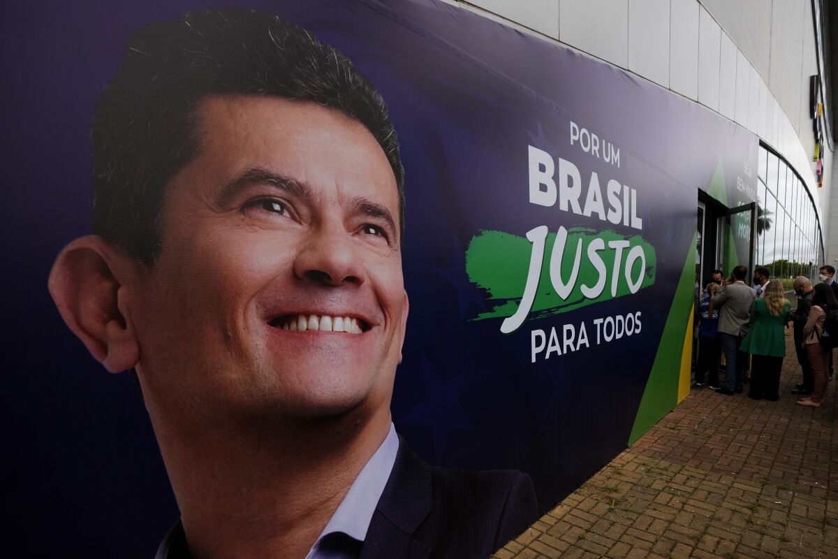 FILE - A poster shows former Federal Judge and former Justice Minister Sergio Moro before a ceremony where he will join the Podemos party and present his intention to run in the 2022 presidential election in Brasilia, Brazil, Nov. 10, 2021. Brazil’s Federal Police conducted an operation on March 22, 2023 targeting a criminal organization that was plotting assassinations and kidnappings of authorities and public servants, including Moro, who presided as a judge over the Carwash corruption investigation. (AP Photo/Eraldo Peres, File)