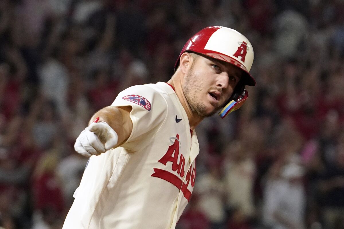 The Angels' Mike Trout gestures as he rounds first base after hitting a solo homer during the fifth inning.