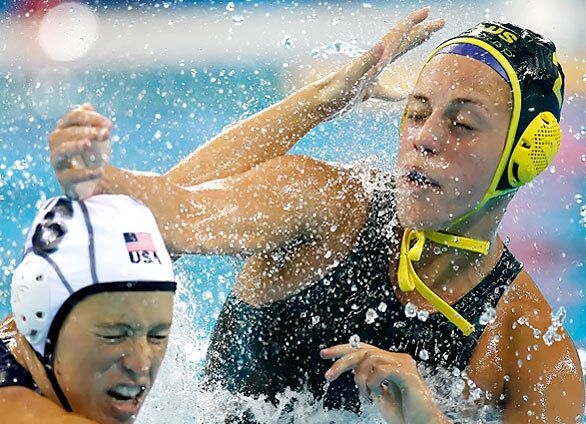 Australia's Gemma Beadsworth's follow-through slams into the head of U.S. defender Natalie Golda in the second half of a women's water polo semifinal at the Yingdong Natatorium in Beijing.