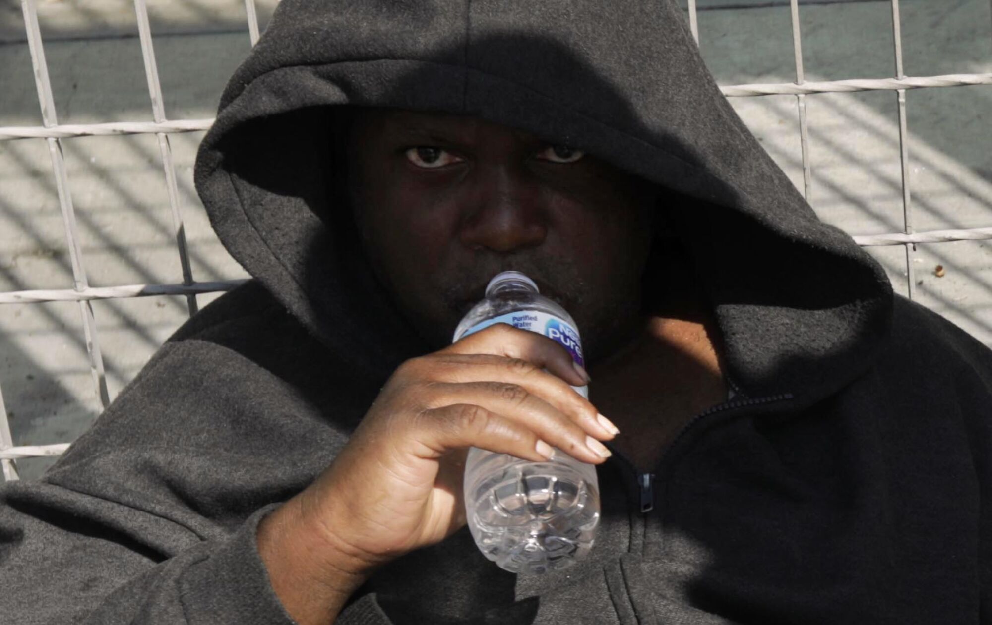 Marc Washington, 45, drinks water given to him by a team from the Midnight Mission.