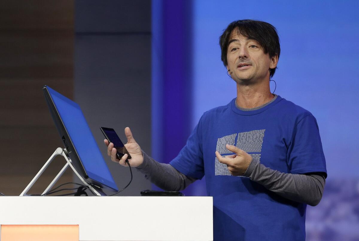 Joe Belfiore, Microsoft corporate vice president of operating systems, demonstrates a Windows 10 feature called Continuum, which lets smartphones connected to a monitor display a desktop version of the operating system.