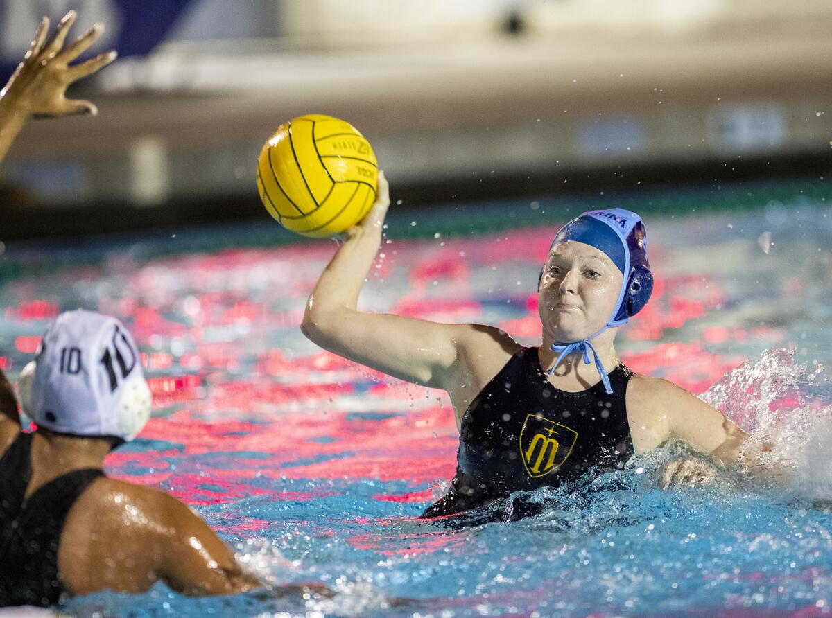 Marina's Maddison Clobes takes a shot against Edison's Sam Worley during a Wave League match at Corona del Mar High on Thursday.
