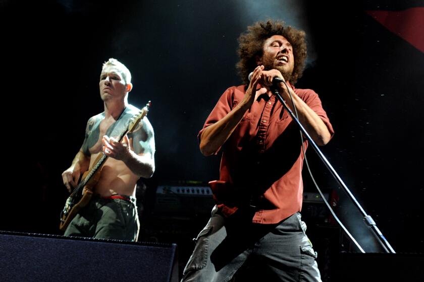 LOS ANGELES, CA - JULY 30: Musician Tim Commerford (L) and singer Zack de la Rocha of Rage Against the Machine performs at L.A. Rising at the L.A. Memorial Coliseum on July 30, 2011 in Los Angeles, California. (Photo by Kevin Winter/Getty Images)