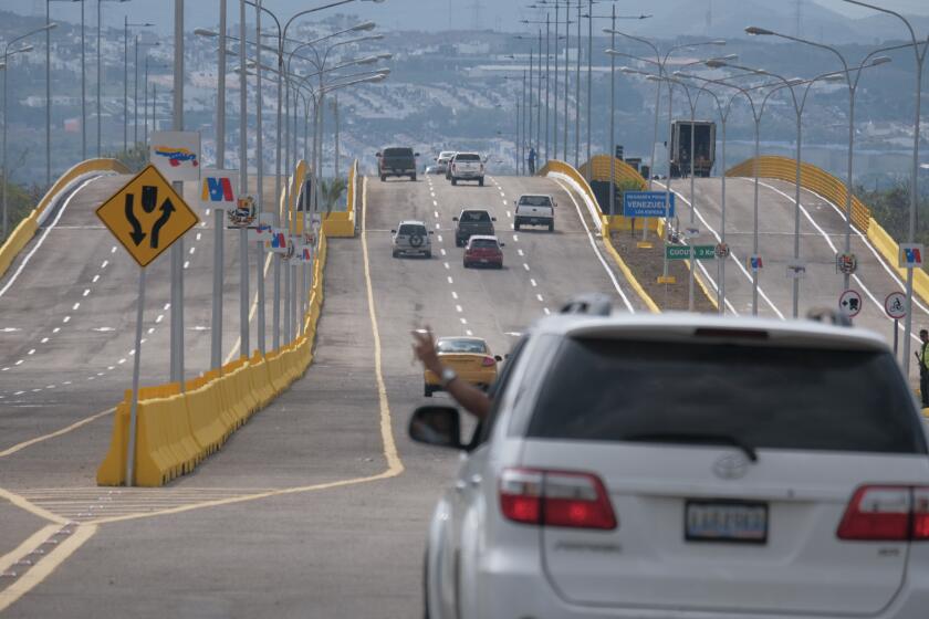 Cars cross the Tienditas International Bridge in San Antonio, Tachira state, Venezuela, Sunday, Jan. 1, 2023. Colombia and Venezuela on Sunday opened the bridge that was finished in 2016 but never inaugurated because years of political tensions. (AP Photo/Ferley Ospina)