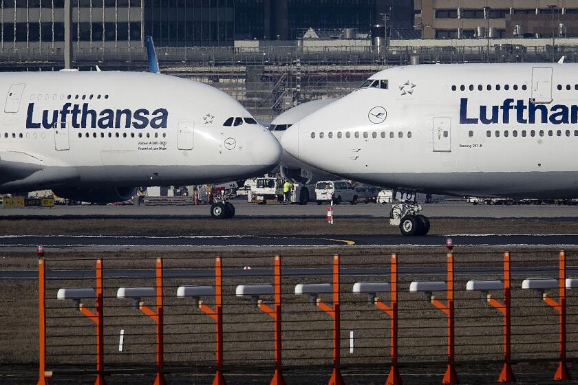 FILE - In this Feb.14, 2019 file photo, an Airbus A380, left, and a Boeing 747, both from Lufthansa airline pass each other at the airport in Frankfurt, Germany. The United States and the European Union on Tuesday appeared close to clinching a deal to end a damaging dispute over subsidies to Airbus and Boeing and lift billions of dollars in punitive tariffs. (AP Photo/Michael Probst, File)