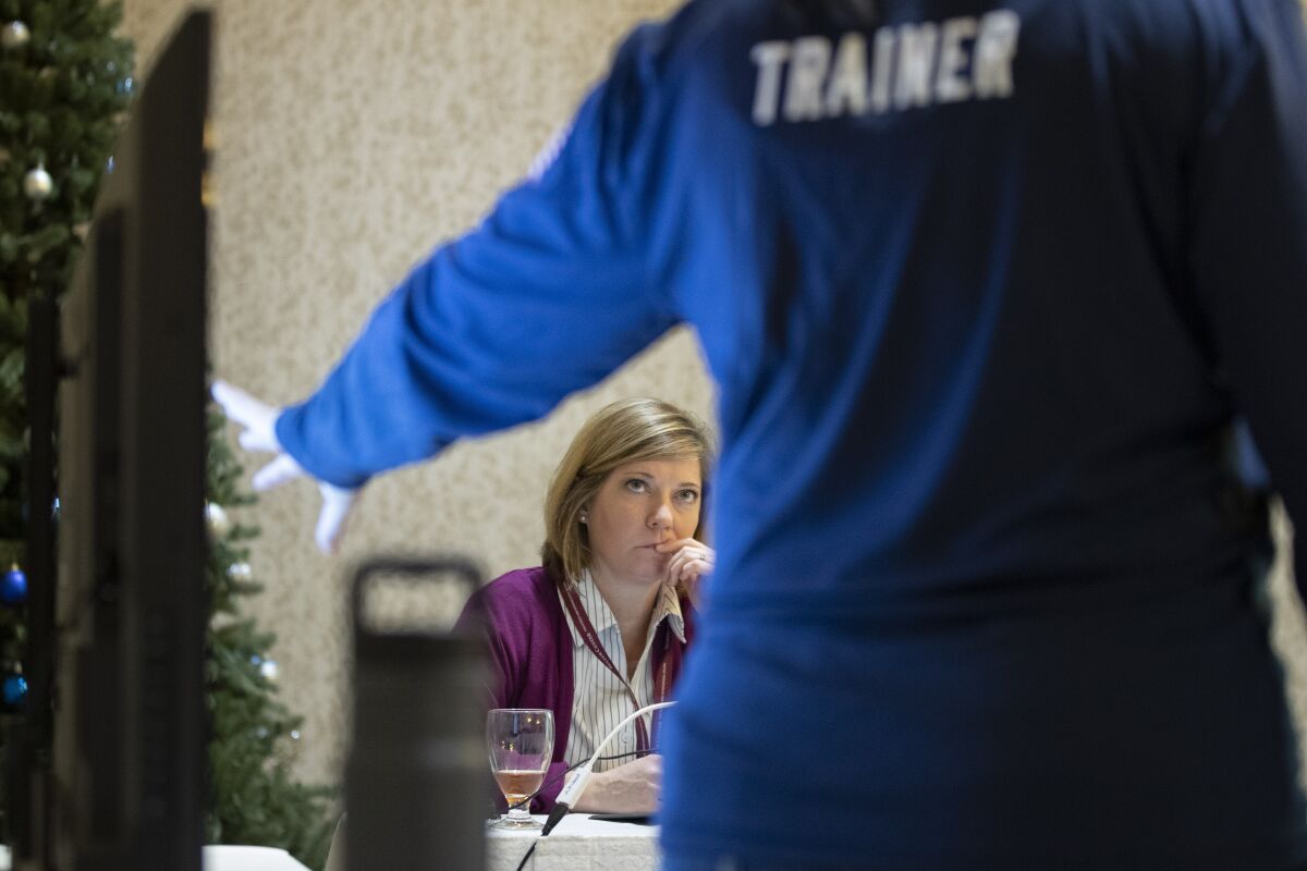 Karen Brenson Bell of North Carolina listens during an exercise for state and local election officials to simulate different election scenarios.