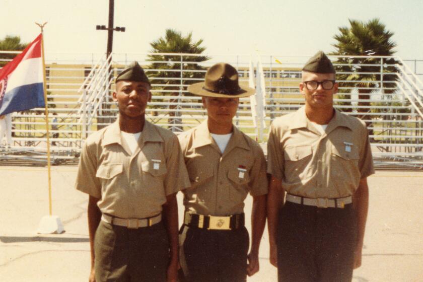 Comedian and TV host Drew Carey (far right), a former U.S. Marine, stands at attention at boot camp graduation. 