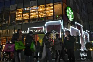 Shoppers walk by a Starbucks cafe at an outdoor shopping mall in Beijing on Saturday, Dec. 23, 2023. It was tumultuous 2023 for the Chinese economy. Some of the world's biggest brands said they were weighing, or already have decided, to shift manufacturing away from China amid unease about security controls, government protection of their Chinese rivals and Beijing's wobbly relations with Washington. But there was at least one bright spot for Beijing amid all the tough news about declining foreign investment: American fast food companies have announced a surge of investment in a market of 1.4 billion people. KFC, McDonald's and Starbucks are among companies in recent months that have announced plans for major investment in China. (AP Photo/Andy Wong)