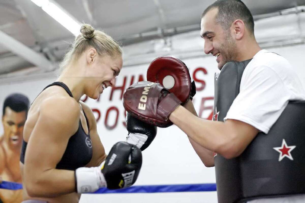 ARCHIVE PHOTO: Edmond Tarverdyan, right, says Ronda Rousey, who trains at the Glendale Fighting Club, is reportedly very motivated and happy while training on location in Bulgaria for the filming of the "The Expendables 3."