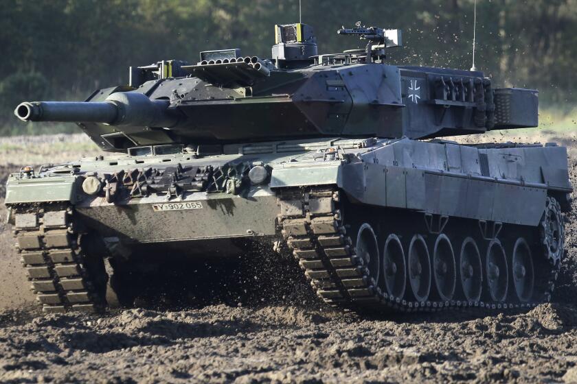 FILE - A Leopard 2 tank is pictured during a demonstration event held for the media by the German Bundeswehr in Munster near Hannover, Germany, Wednesday, Sept. 28, 2011. Poland will apply to the German government for permission to supply the German-made Leopard battle tanks to Ukraine. (AP Photo/Michael Sohn, File)