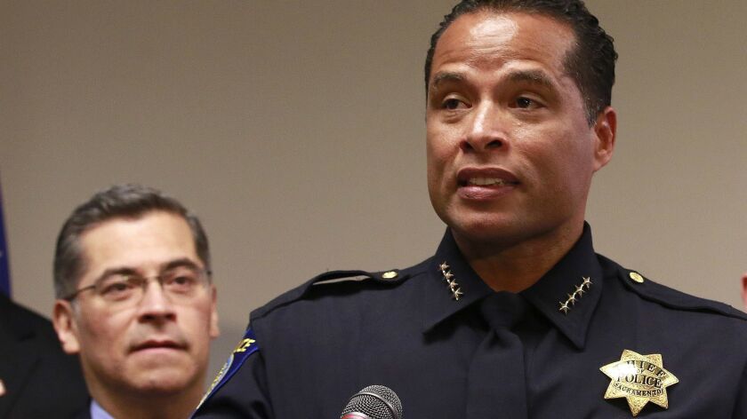 Sacramento Police Chief Daniel Hahn addresses reporters at a news conference in Sacramento in March. Hahn and state Atty. Gen. Xavier Becerra, left, on Friday announced a $50,000 reward in an effort to solve the slaying of a young family nearly 30 years ago.