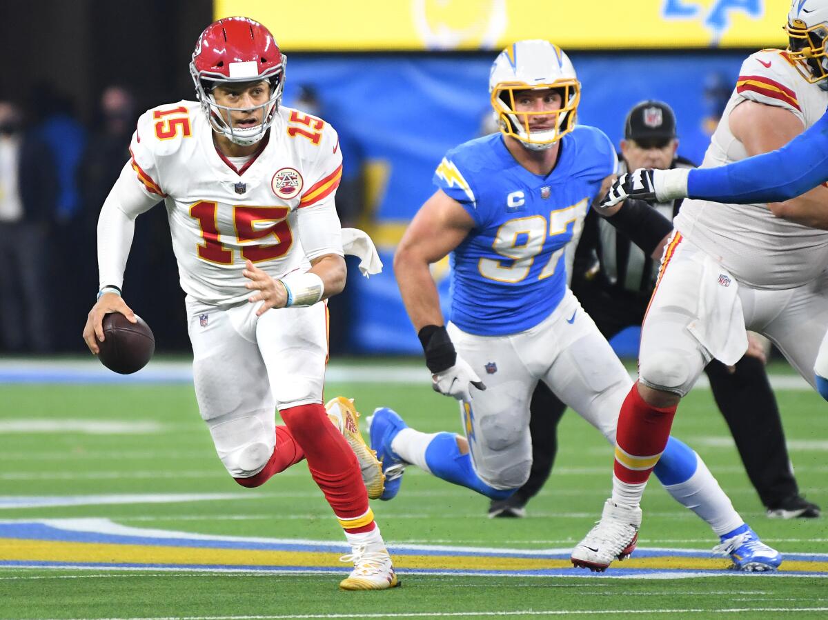Chiefs quarterback Patrick Mahomes scrambles away from Chargers outside linebacker Joey Bosa during the fourth quarter.