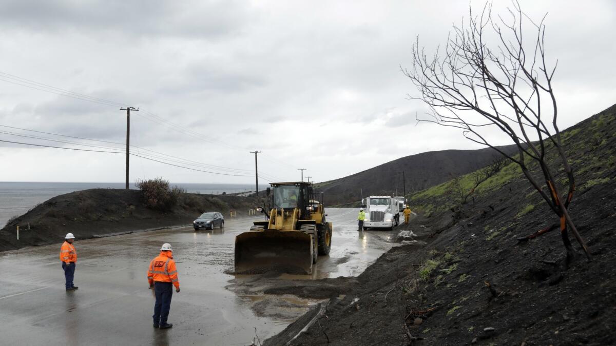 A crew works to clear mud from Pacific Coast Highway near Leo Carrillo Beach in Malibu.