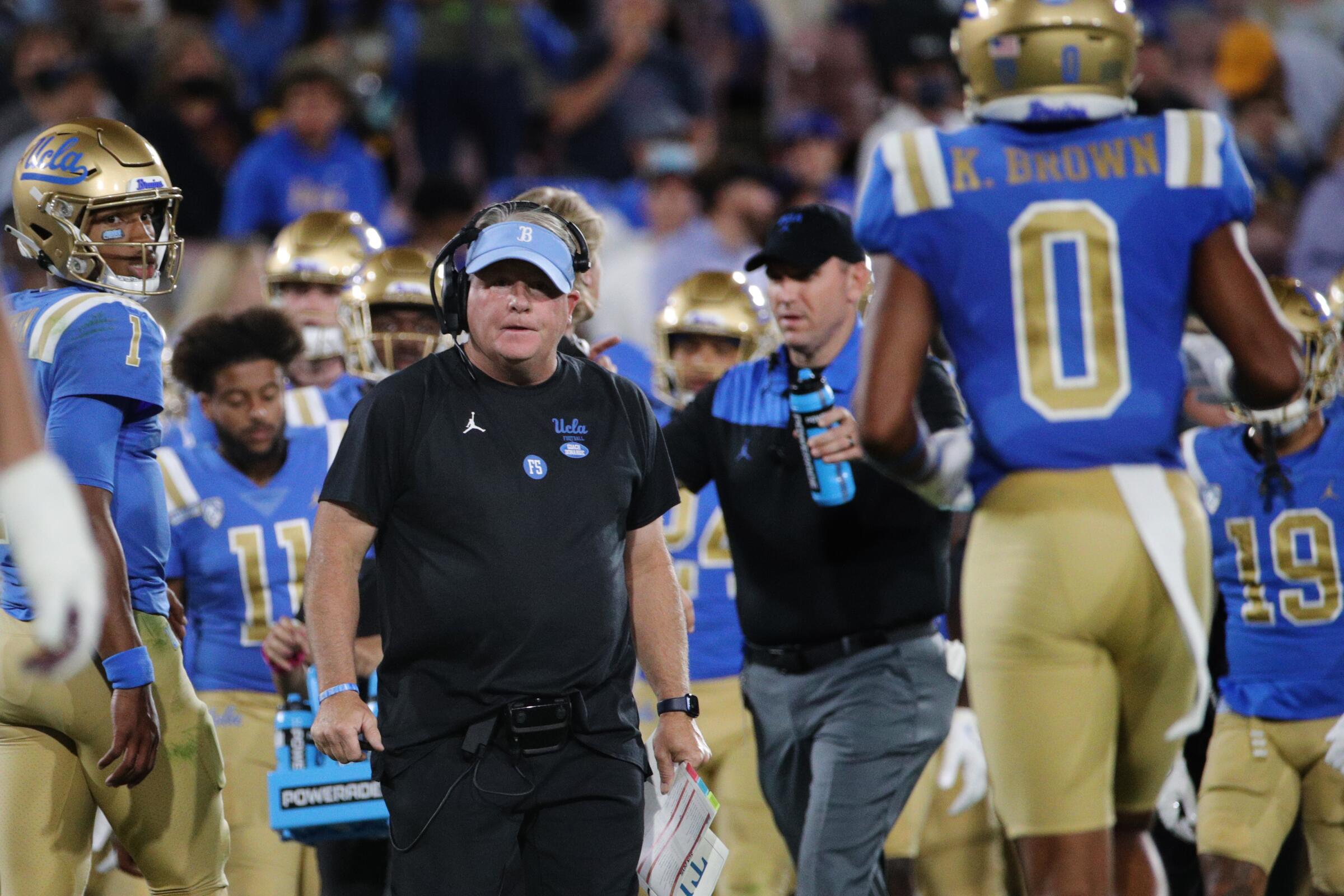  UCLA head coach Chip Kelly stares down Bruins wide receiver Kam Brown.