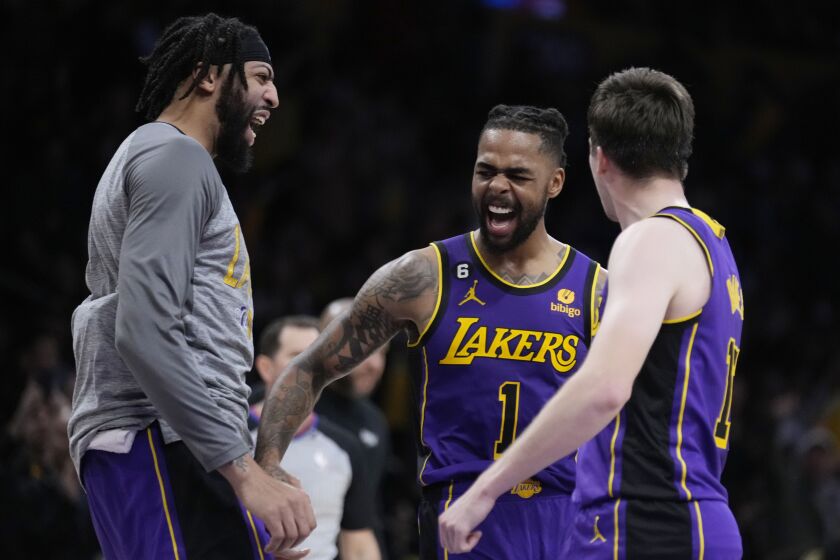 Los Angeles Lakers guard D'Angelo Russell, center, celebrates after making a 3-point basket with forward Anthony Davis.