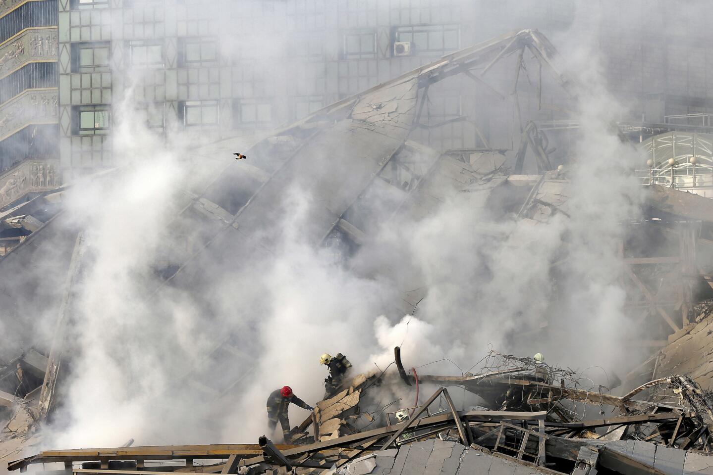 Iranian firefighters work at the scene of the Plasco building after it was engulfed by a fire and collapsed on Jan. 19, 2017, in Tehran.