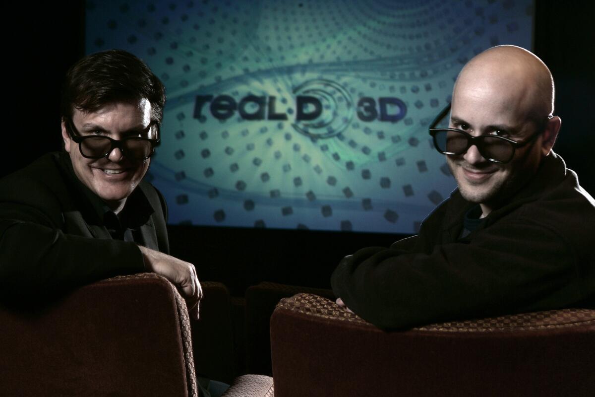 RealD founders Michael Lewis and Josh Greer wearing 3-D glasses inside the theater at their Beverly Hills headquarters.