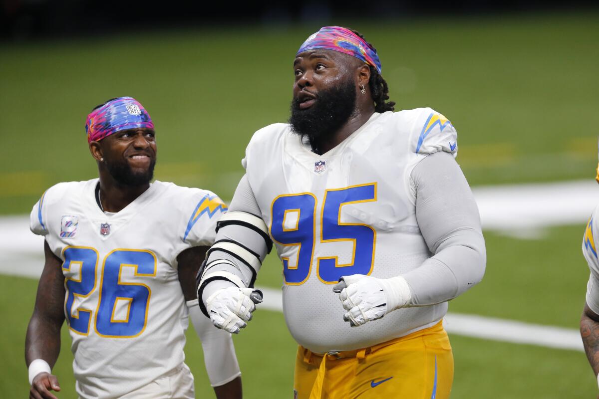 Chargers defensive tackle Linval Joseph (95) and cornerback Casey Hayward walk off the field.