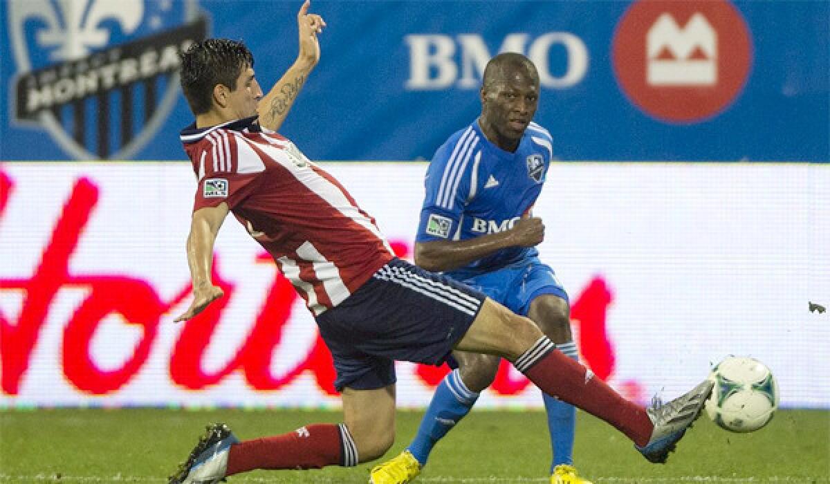 Carlos Borja, left, challenges Montreal's Sanna Nyassi for the ball during second half of Chivas USA's draw with the Impact, 1-1, on July 7, 2013.