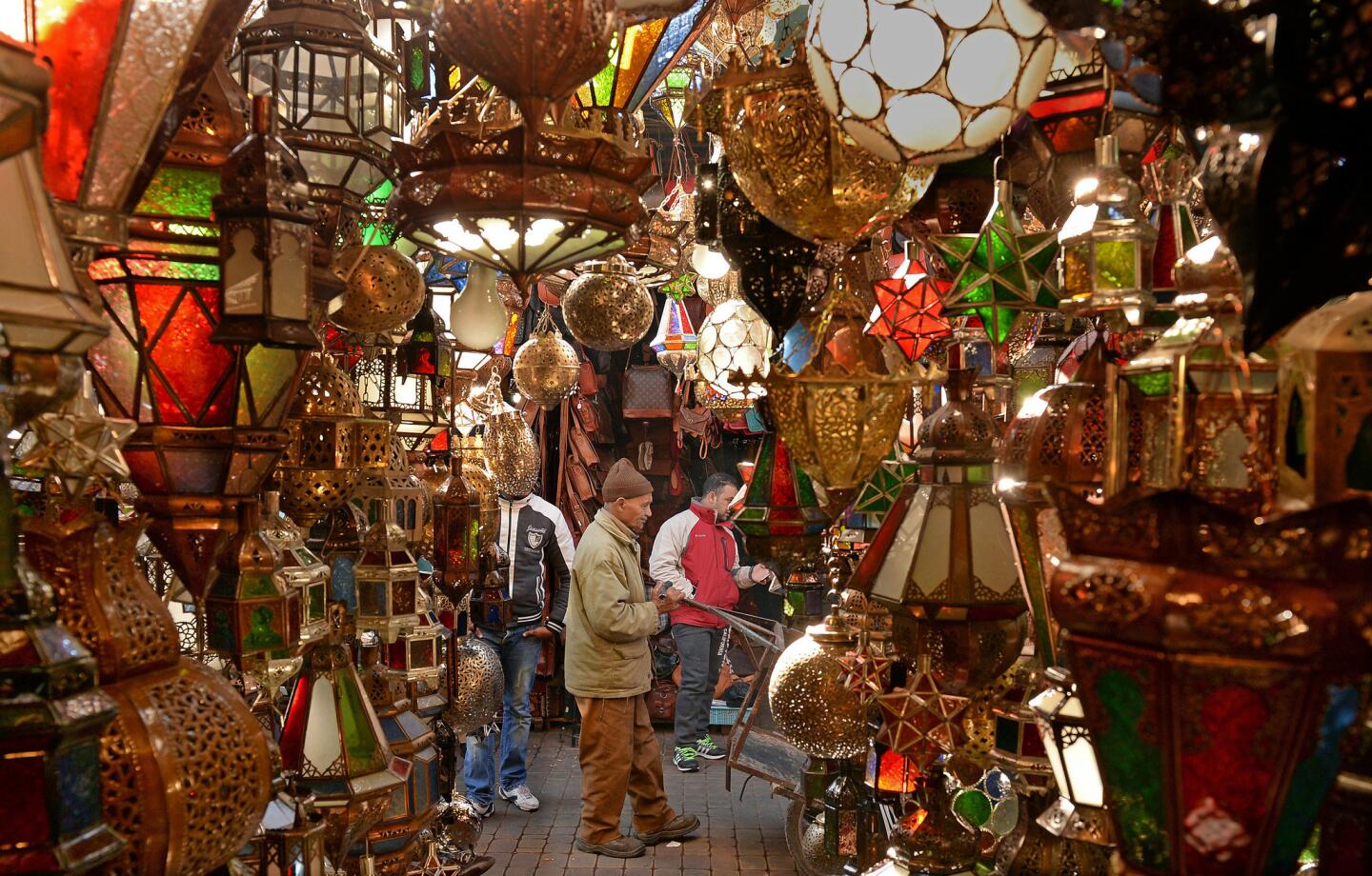 Customer inspect goods in an alley of a traditional souk (marketplace).