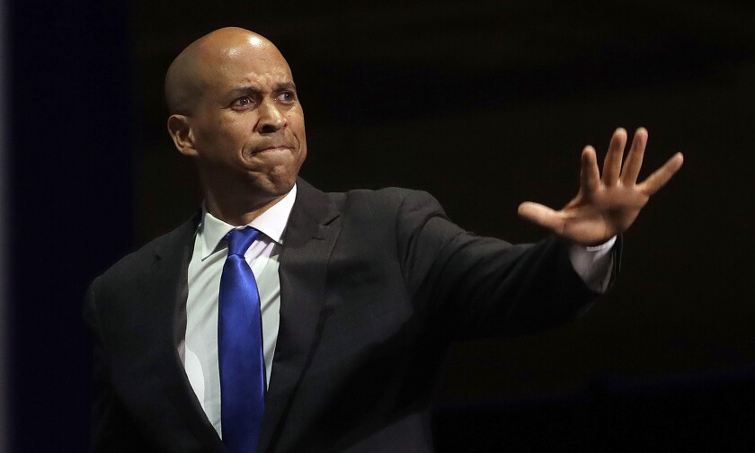 FILE - In this June 1, 2019 file photo, Democratic presidential candidate Sen. Cory Booker, of New Jersey, waves before speaking during the 2019 California Democratic Party State Organizing Convention in San Francisco. Booker has dropped out of the presidential race after failing to qualify for the December primary debate. (AP Photo/Jeff Chiu)