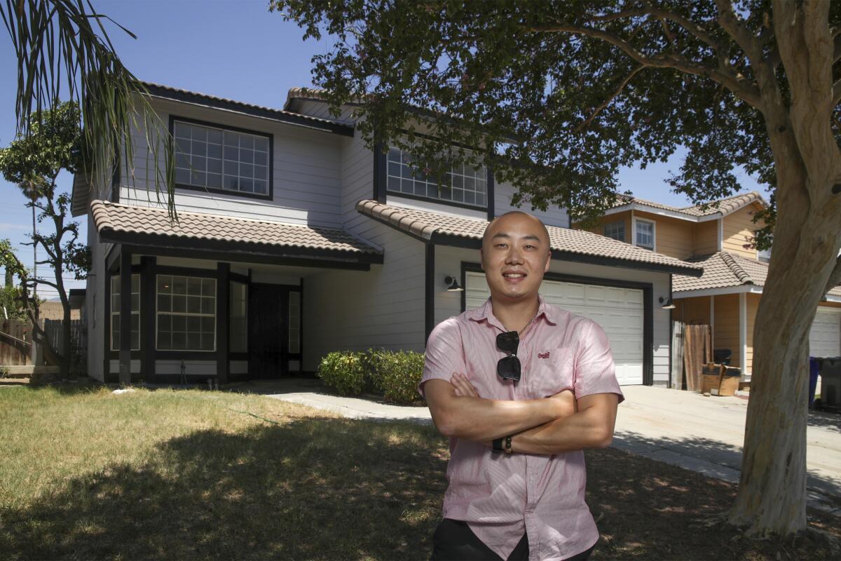 Kevin Chen in front of a Rialto home he is renting out. 