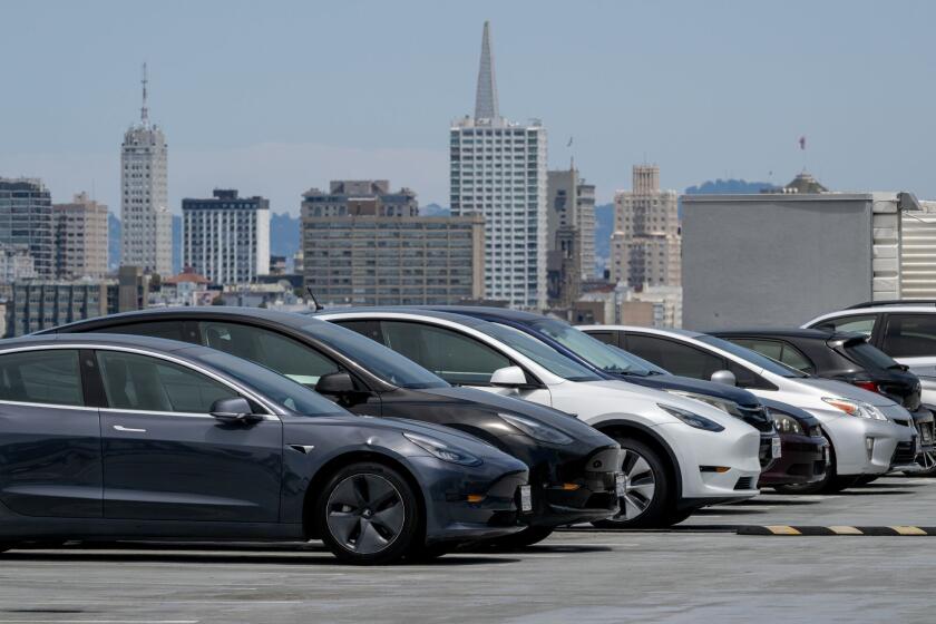 Tesla Inc. electric vehicles at a charging station in San Francisco. Photographer: David Paul Morris/Bloomberg