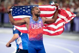 American Noah Lyles celebrates after winning the men's 100-meter final at the 2024 Paris Olympics at Stade de France