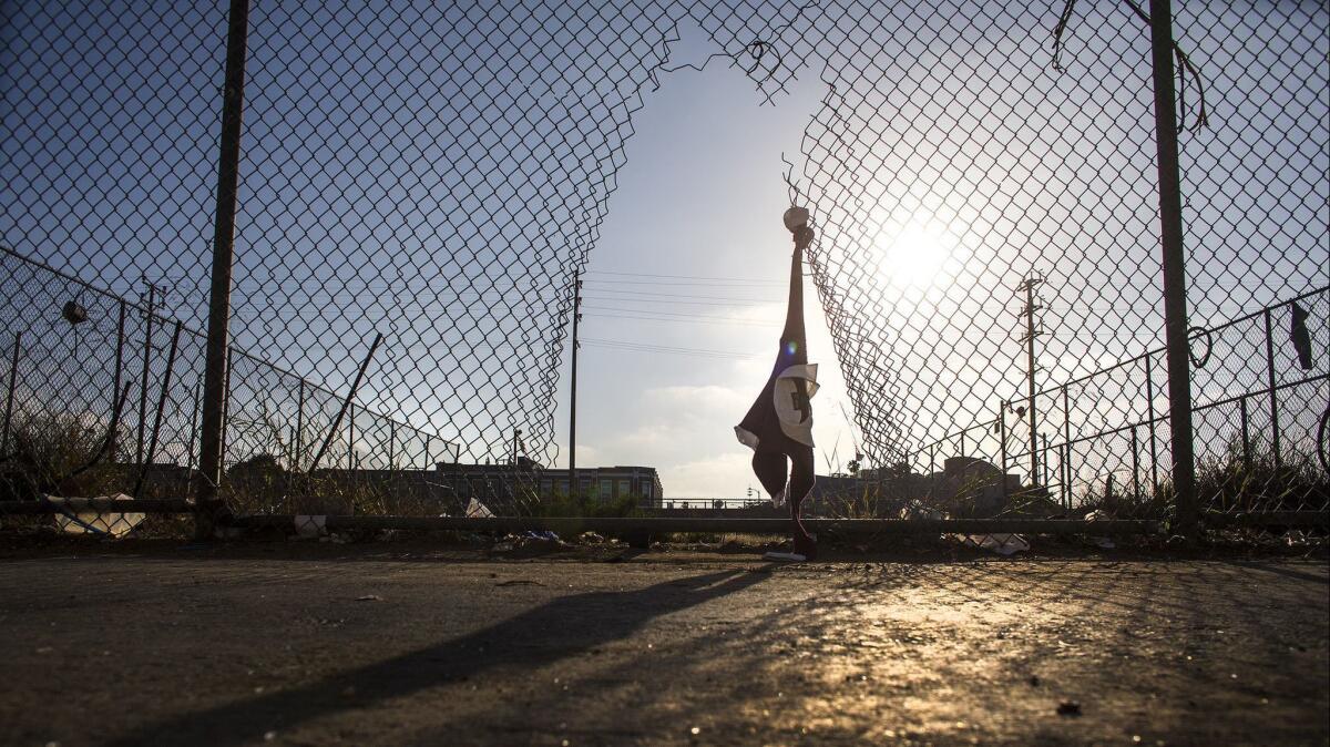 Torn fencing, tattered clothing and garbage are all that remain in the vacant lot in the 8400 block of Vermont Avenue near Manchester Avenue.