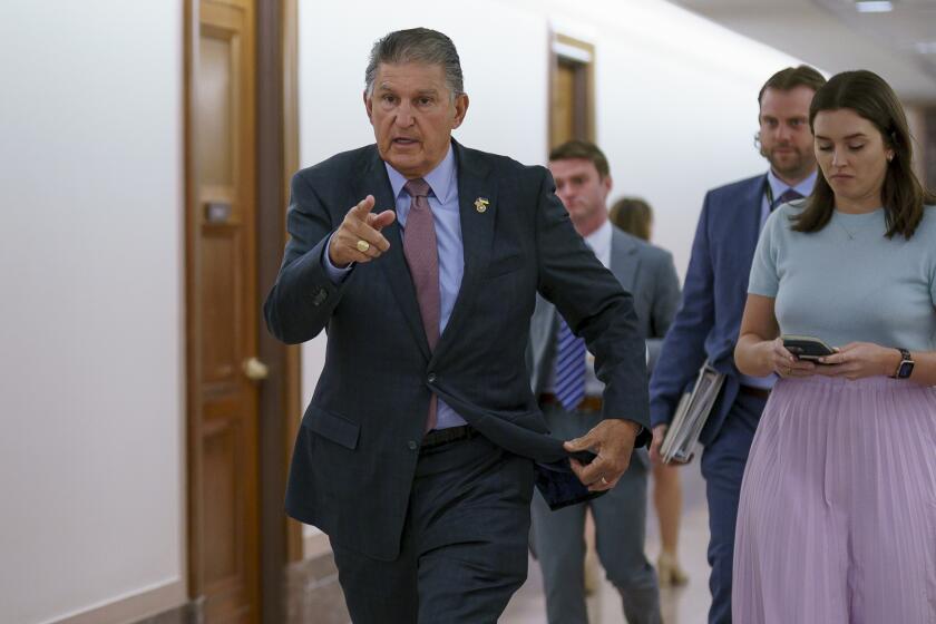 Sen. Joe Manchin, D-W.Va., is met by reporters outside the hearing room where he chairs the Senate Committee on Energy and Natural Resources, at the Capitol in Washington, Tuesday, July 19, 2022. (AP Photo/J. Scott Applewhite)