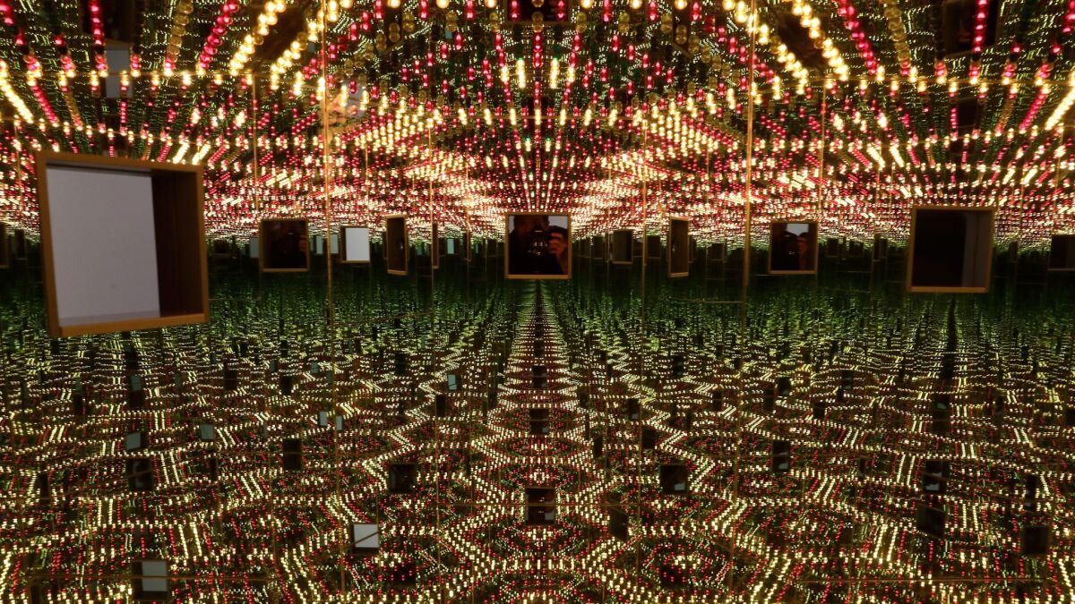 Kusama's "Infinity Mirrored Room — Love Forever," with twin peepholes to look at the changing lights inside.