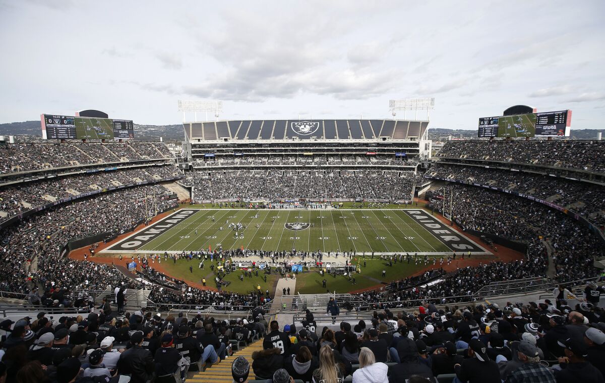 Fans watch the Raiders play the Carolina Panthers at Oakland Alameda County Coliseum on Nov. 27.