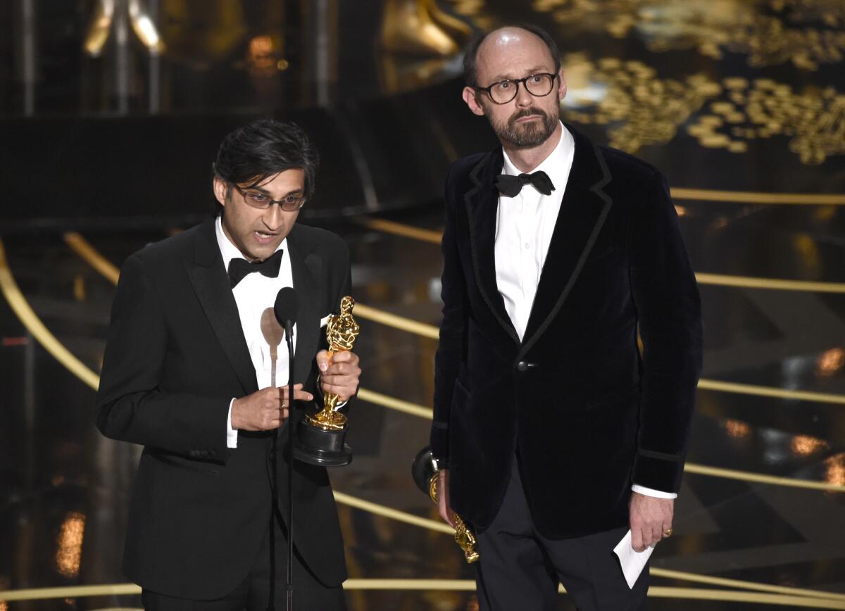 Asif Kapadia, left, and James Gay-Rees accept the award for best documentary feature for “Amy” at the Oscars on Sunday, Feb. 28, 2016, at the Dolby Theatre in Los Angeles.