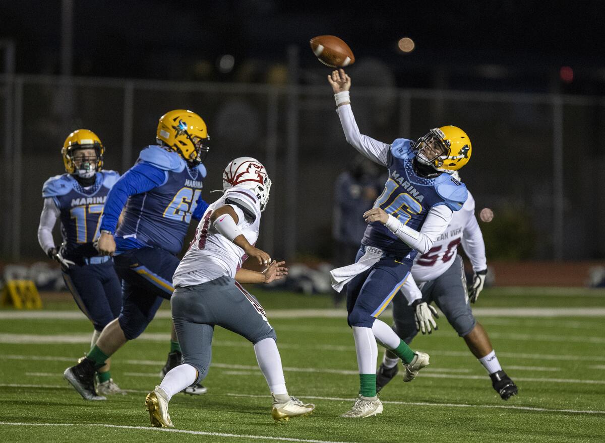 Marina's Jack Miller throws a pass under pressure from Ocean View's Jeffrey Garcia during a game on Wednesday, March 17.