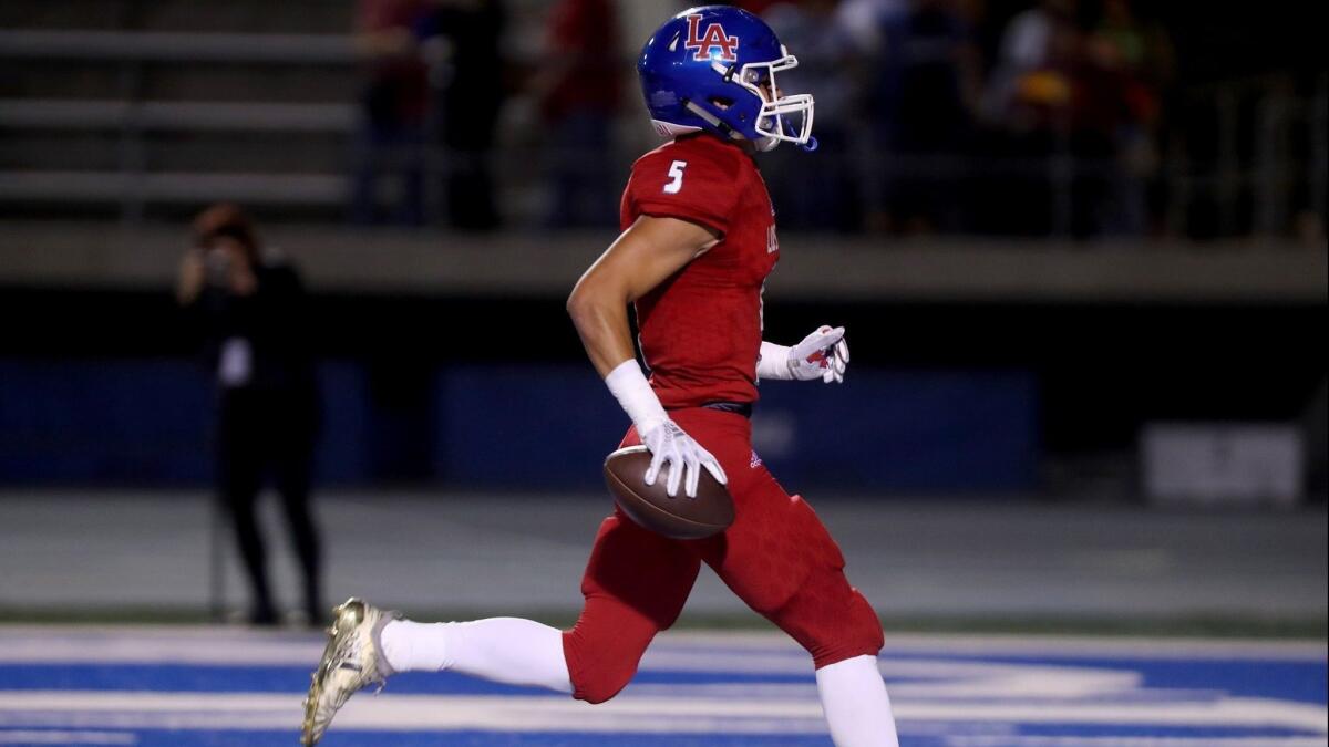 Los Alamitos High's Keanu Norman, pictured scoring a touchdown against Newport Harbor on Oct. 5, helped the Griffins stay atop the Sunset League on Friday.