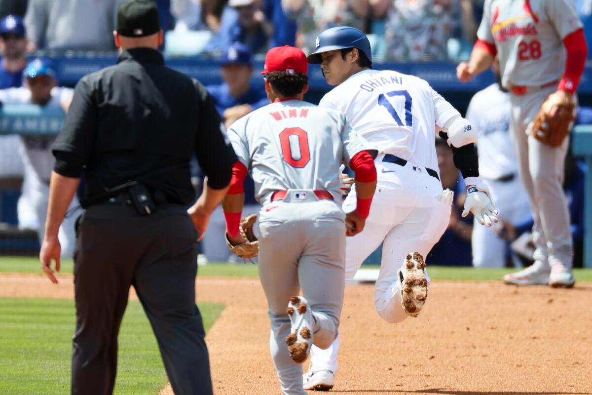 Dodgers star Shohei Ohtani is chased down between second and third bases during the Dodgers' home opener.