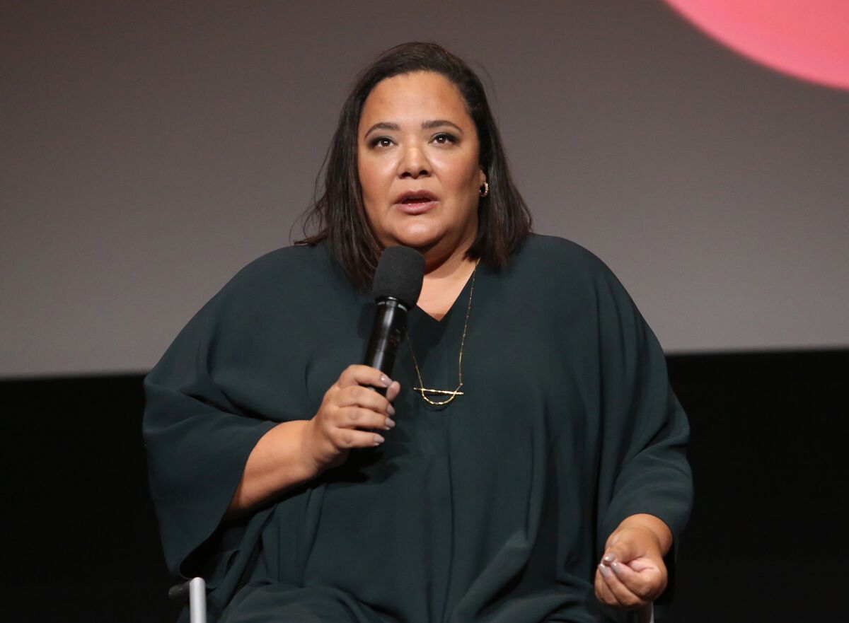 A woman speaks into a microphone.