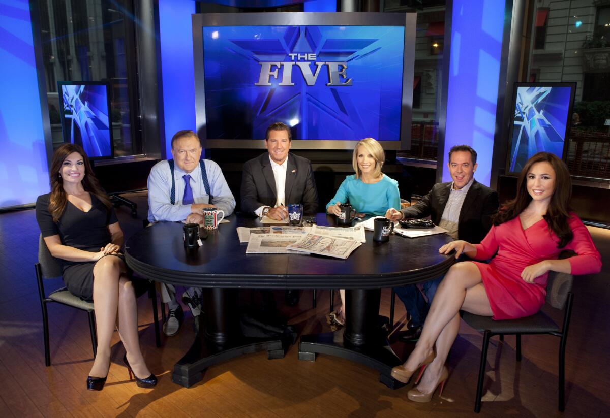 This July photo shows the co-hosts of Fox News Channel's popular "The Five" -- Kimberly Guilfoyle, Bob Beckel, Eric Bolling, Dana Perino, Greg Gutfeld and Andrea Tantaros -- following a taping of the show in New York. A Gallup poll said Americans are most likely to turn to their TV news.