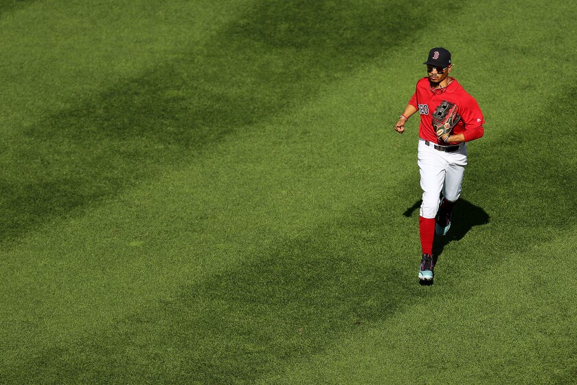 Mookie Betts runs off the field during a Red Sox game.